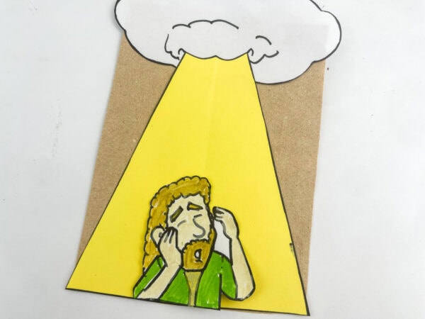 A straight-on view of the finished Saul conversion paper bag craft centered on a plain white surface.