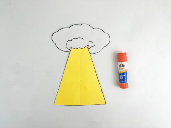Paper cloud glued to the top of the yellow beam shape, placed next to an orange glue stick.
