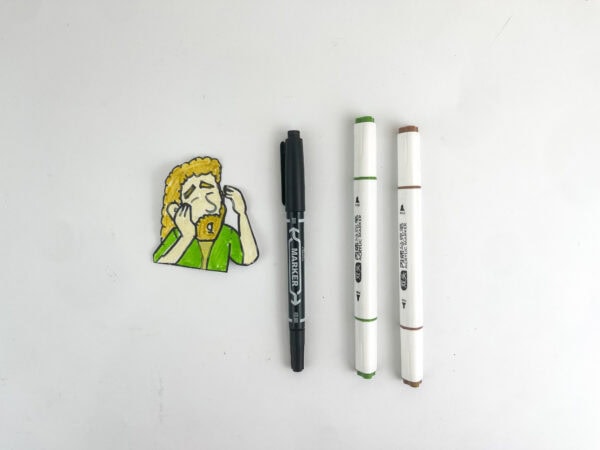 Colored paper cutout of the character Saul next to three markers.