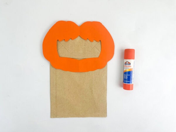 Glue hair and beard onto paper bag