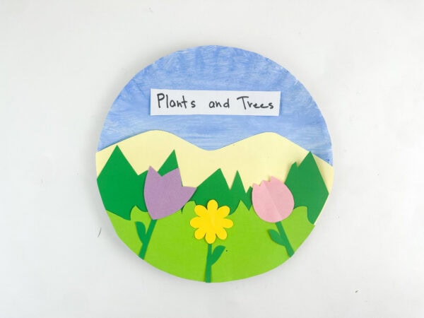 Top-down view of the completed paper plate landscape craft on a plain white background.