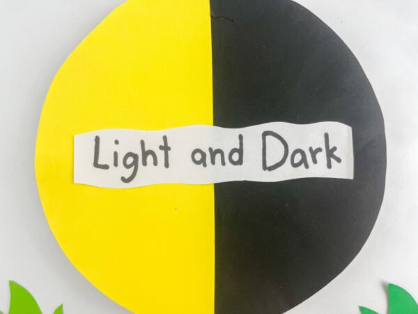 Close-up of a yellow and black paper circle with a "Light and Dark" label.