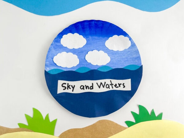 A completed paper plate craft depicting a blue sky with paper clouds and wavy blue paper ocean water labeled "Sky and Waters."