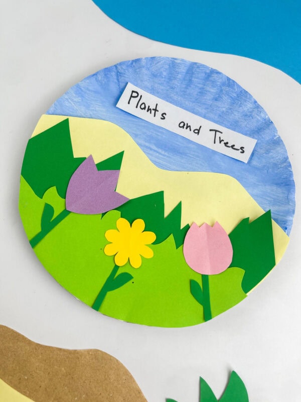Close-up, angled view of the completed "Plants and Trees" paper plate landscape craft.