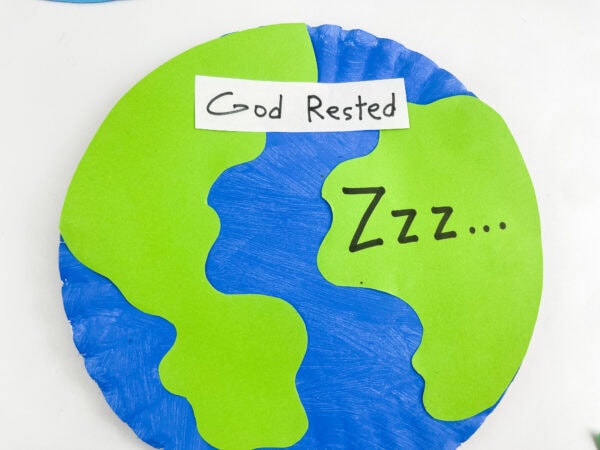 A close-up view of the finished paper plate Earth craft on a white background.