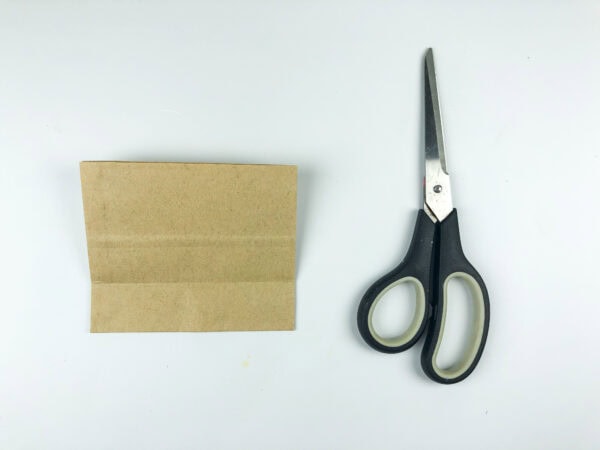 Folded paper bag and scissors