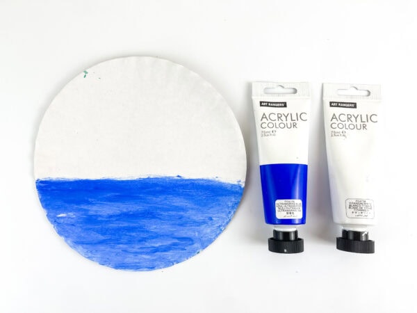 Paper plate painted blue for water scene