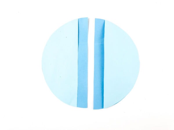 A light blue circle with two vertical cuts forming a narrow blue strip down the middle.