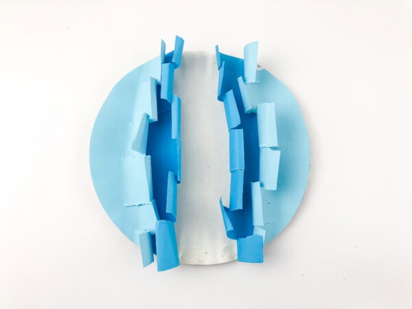 The jagged half-circles taped upright, standing vertically to form a 3D wave shape.