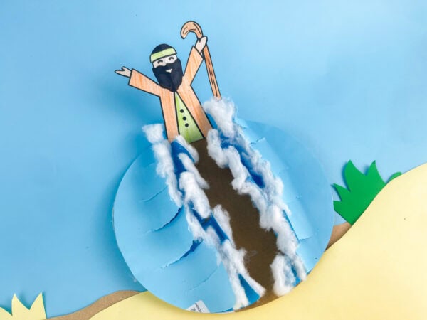 The scene with added sand-colored ground and green grass tufts around the wave craft and figure.