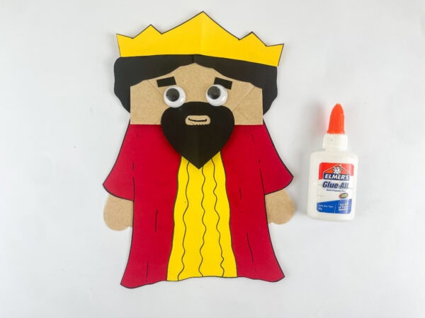 King Solomon paper bag puppet with googly eyes and face details completed Bible craft for kids