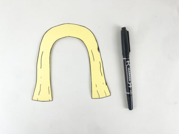 adding black marker texture lines to cream veil piece for Deborah paper bag puppet Bible craft