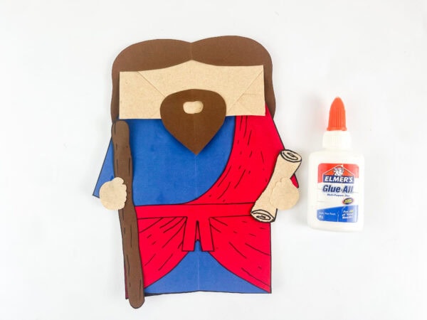 Ezekiel paper bag puppet with brown hair beard staff and scroll assembled before adding googly eyes