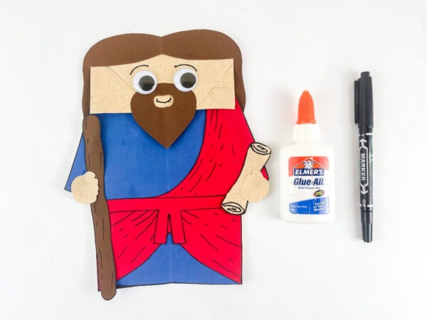 Ezekiel paper bag puppet with googly eyes and face details nearly complete Bible craft for kids
