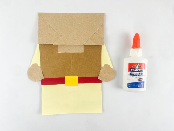 assembling Gideon paper bag puppet body with robe vest belt and buckle construction paper

