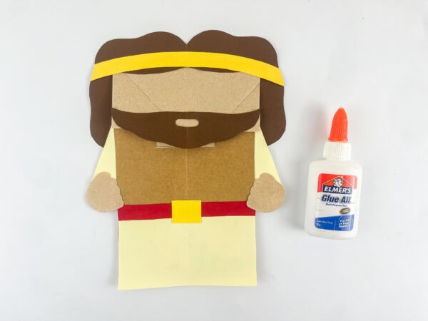 Gideon paper bag puppet with hair beard and headband assembled before adding eyes and details

