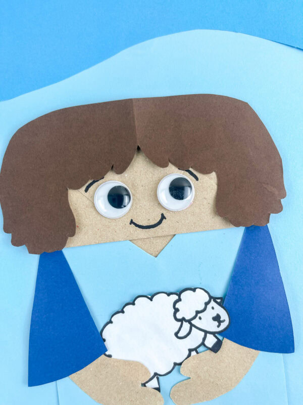 Close-up of Abel holding a sheep.