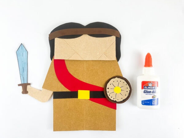 Attaching the sword and shield to the Joshua puppet.