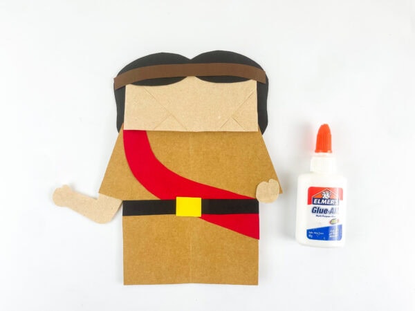 Adding Joshua’s hair and headband to the paper bag
