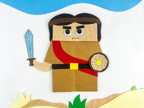 Finished Joshua paper bag craft on a desert background.