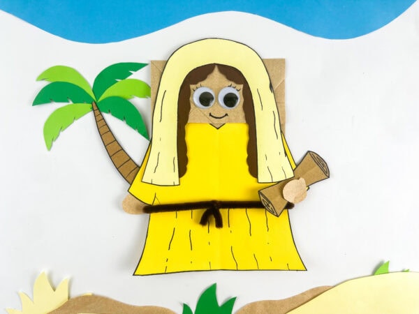 completed Deborah Bible craft paper bag puppet with cream veil yellow robe pipe cleaner belt scroll and palm tree kids Sunday school