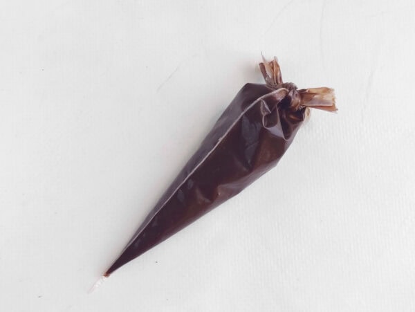 Melted chocolate in a piping bag.