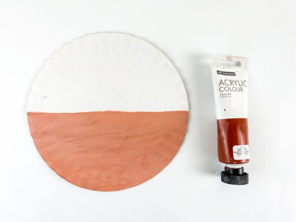 Painting half of a paper plate for a hedgehog craft