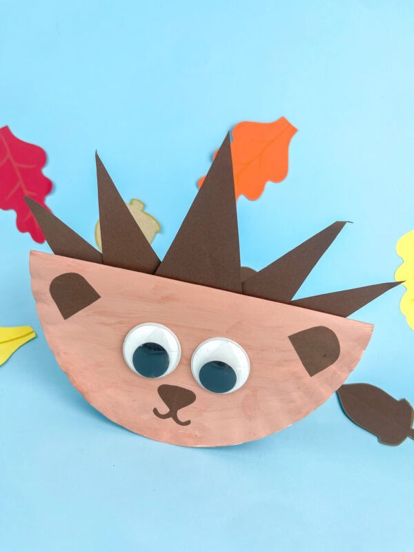 Angled view of a rocking hedgehog craft on blue background