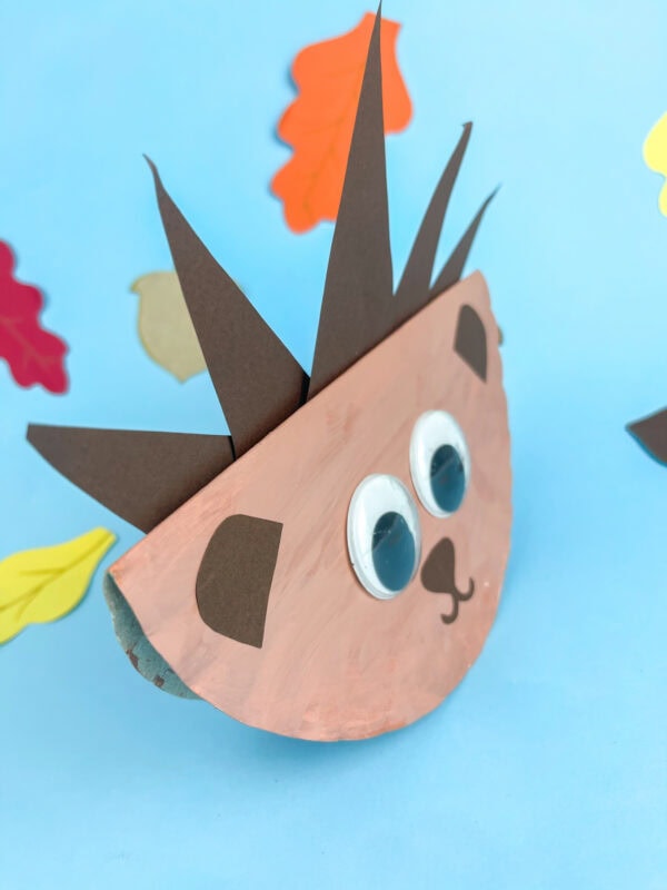 Side view of a rocking hedgehog craft balanced on a curved plate