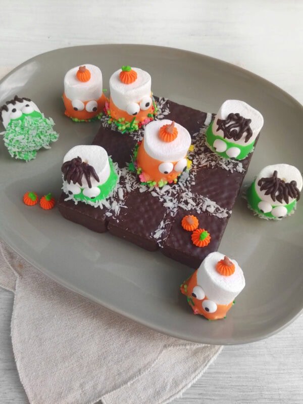 Edible Halloween tic tac toe game with decorated marshmallow monsters.