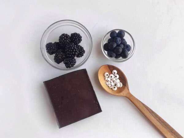 Blackberries, blueberries, dark chocolate, and candy eyes.