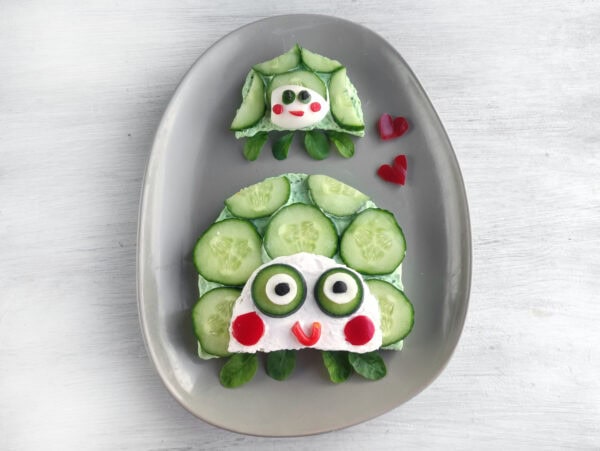 Large and small turtle cucumber sandwiches with spinach feet and smiling faces