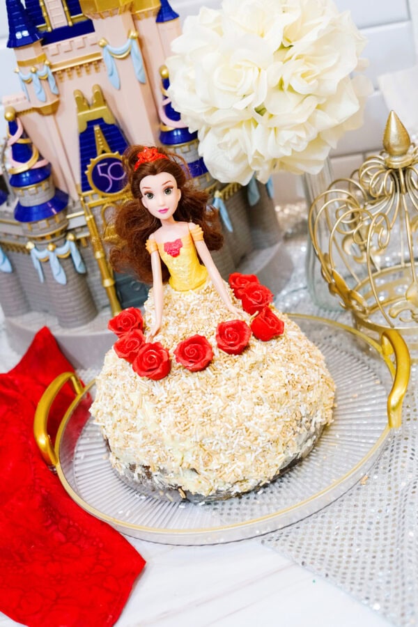Belle birthday cake decorated with gold sprinkles and icing roses