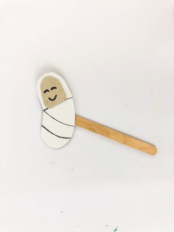 Baby Jesus paper cutout glued to a popsicle stick