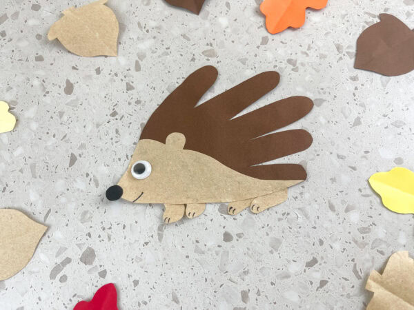 Cute and simple hedgehog handprint craft made from brown construction paper