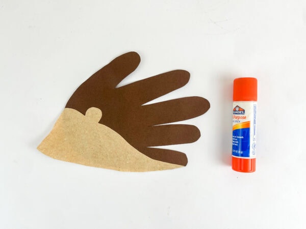 Tan hedgehog body attached to a brown paper handprint