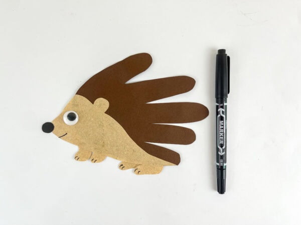 Facial details added to the hedgehog handprint craft for kids