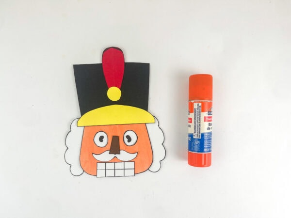 Nutcracker with hat, feather, and gold band attached