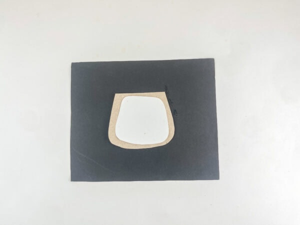 White slider positioned inside the cardboard frame