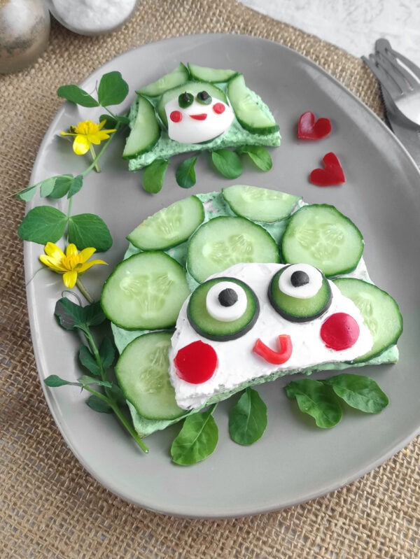 Two turtle cucumber sandwiches for kids with spinach cream cheese and edible faces