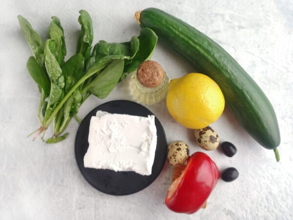 Ingredients for turtle cucumber sandwiches including bread, cucumber, spinach, cream cheese, and lemon