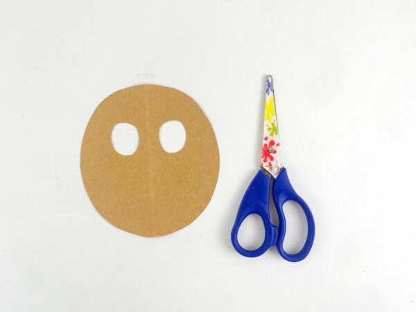  Brown oval reindeer face with two eye openings cut out.