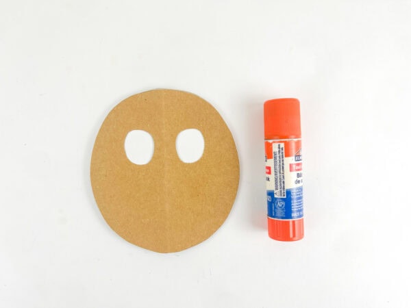 Reindeer face cutout with eye holes and glue stick
