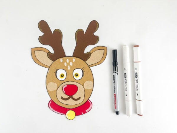 Decorated reindeer craft with drawn eyes and markers