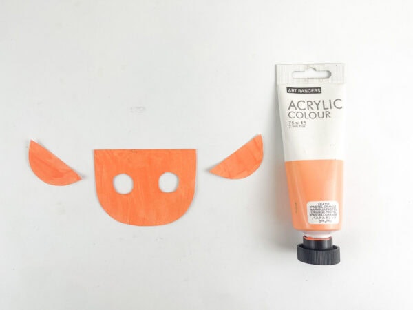 Painted elf face with two eye openings beside the outer ear pieces.